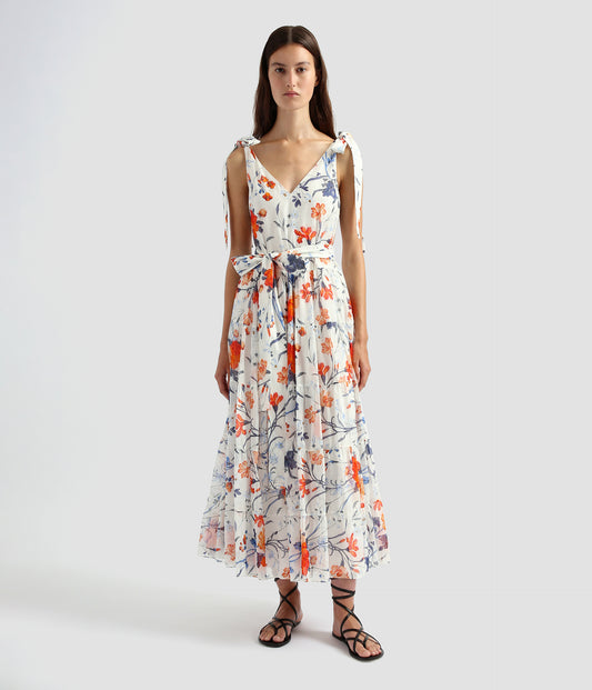 A tiered dress midi length. The tiered midi dress featues a deep v neck, tie straps and a waist belt. The tiered dress is made from white cotton silk voile with a blue and orange floral print. 