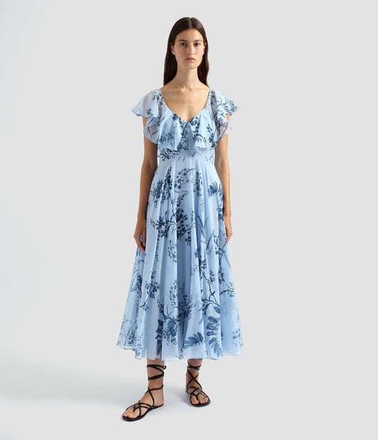 Fit and flare midi dress with a drop v neck, outlined with a cape detail like a collar. The blue fit and flare dress features a willow palm print. 