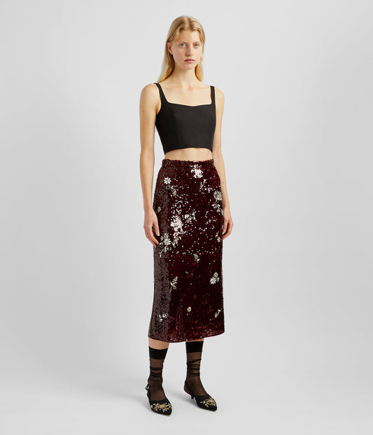 A deep red sequin midi skirt by designer ERDEM. The sequined midi skirt is slimline, with crystal and beaded insect details and falls just below the knee. 