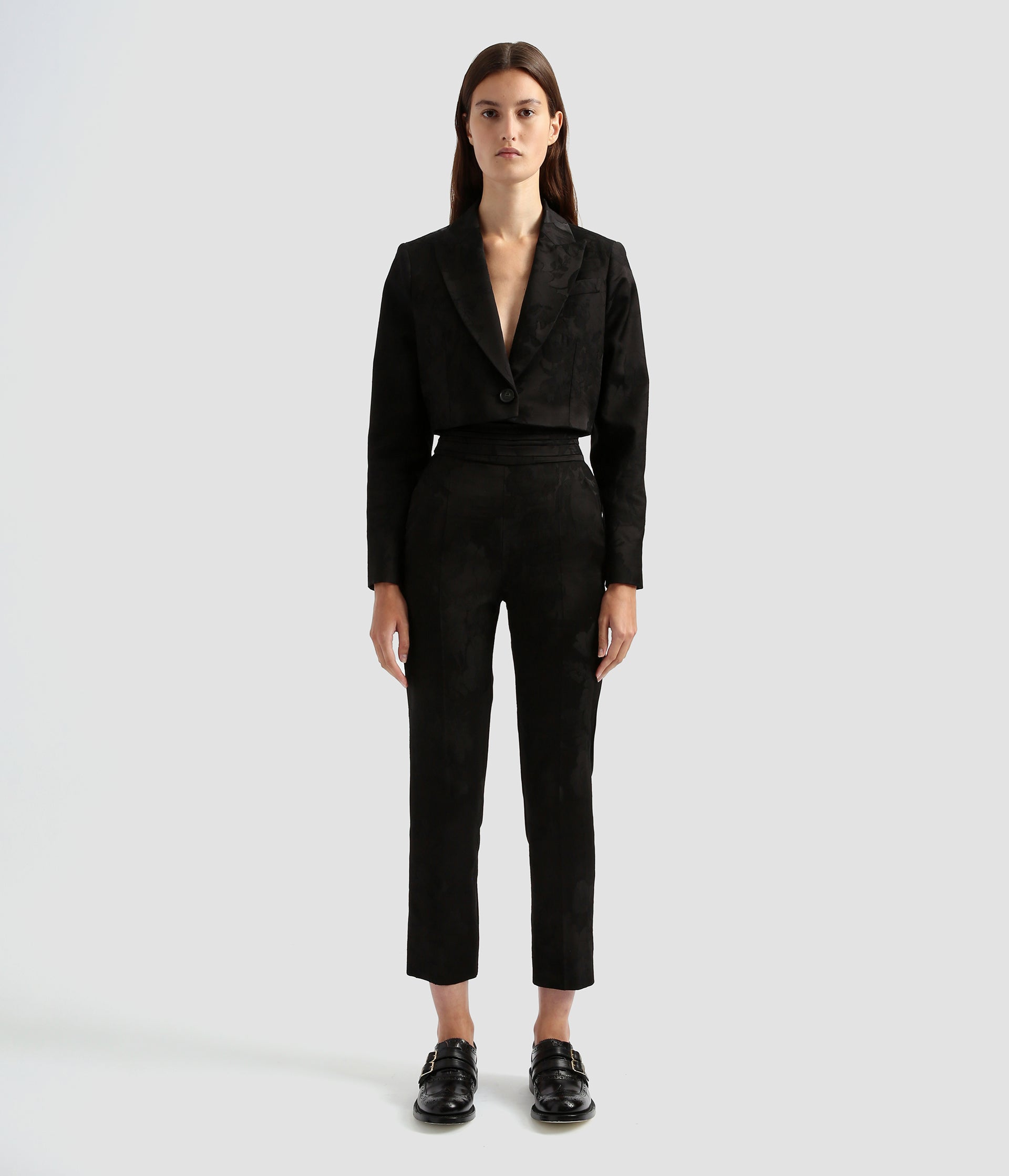 Tailored cropped boxy jacket by the designer Erdem. It's a contemporary take on the classic single breasted blazer with a dramatic crop and deep v neck. Worn here with the matching tailored slim fit trousers.