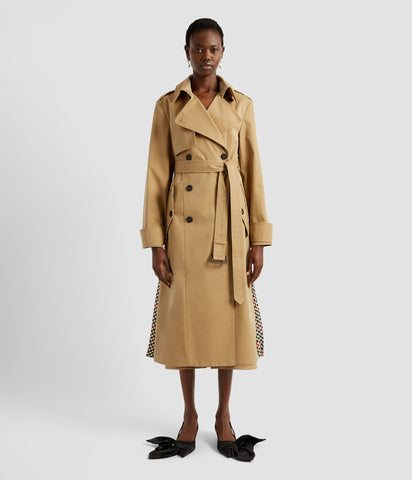 Pleated trench coat by designer ERDEM. From the front it looks like a traditional trench coat, with a classic silhouette but a contrasted checked wool pleated panel is just visible at the sides.