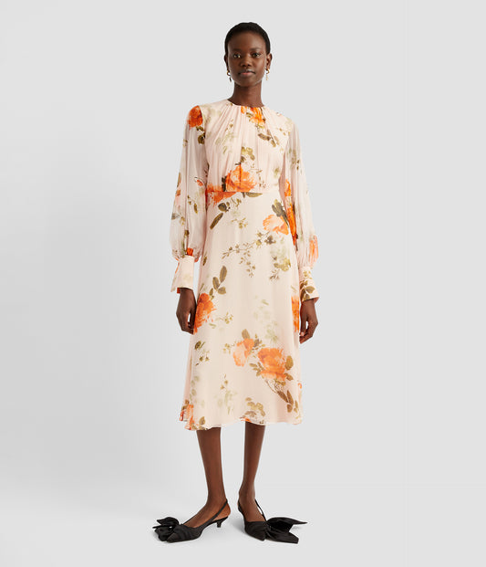 Gathered neck dress with blouson sleeves and slim midi skirt. The gathered neck blouse is crafted from pure pale pink silk with bright orange rose print. 