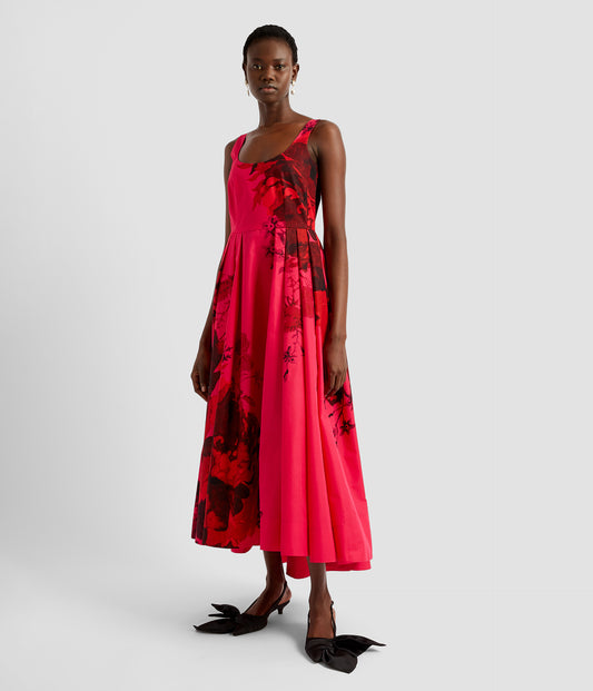 Scoop dress in cerise pink with an abstract rose print by designer ERDEM. The scoop dress is sleeveless with straps and a full skirt with pleats.