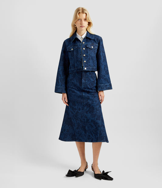 A midi denim skirt made from Asthall Garden design floral printed indigo denim with inserts at the side to give a modern fishtail silhouette. Worn together with the matching jacket. 