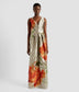 A luxury v neck gown in textured satin by ERDEM. The v neck gown features dramatic pleats at the waist, is sleeveless and has large orange rose motifs. 