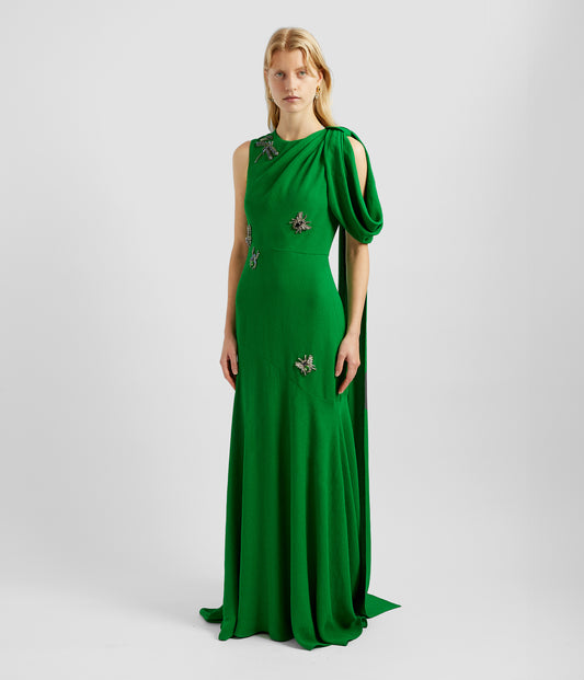 Drape shoulder dress in bright green with crystal embellished insects on the front. Te drape shoulder dress features a loop drape over one shoulder. 