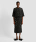 A black cropped cape by desinger Erdem in a textured floral fabric. The cropped cape has elbow length sleeves and crystall embellished insect embroidery and buttons. 
