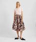 Pink taffeta volume midi skirt with a dark floral print. The skirt features a fitted waist with a gathered flared skirt, that hits just below the knee. 