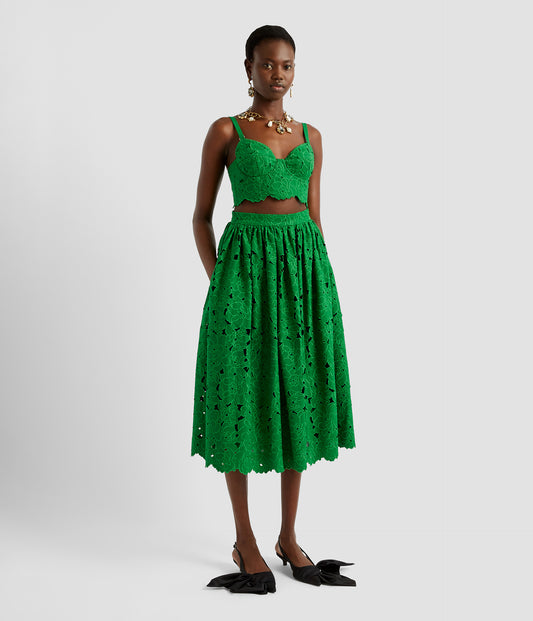 Cutwork lace bralette in a bold green shade. The bralette is structured with slim straps and a delicate cutwork lace hem. Worn with the matching cutwork lace midi skirt. 