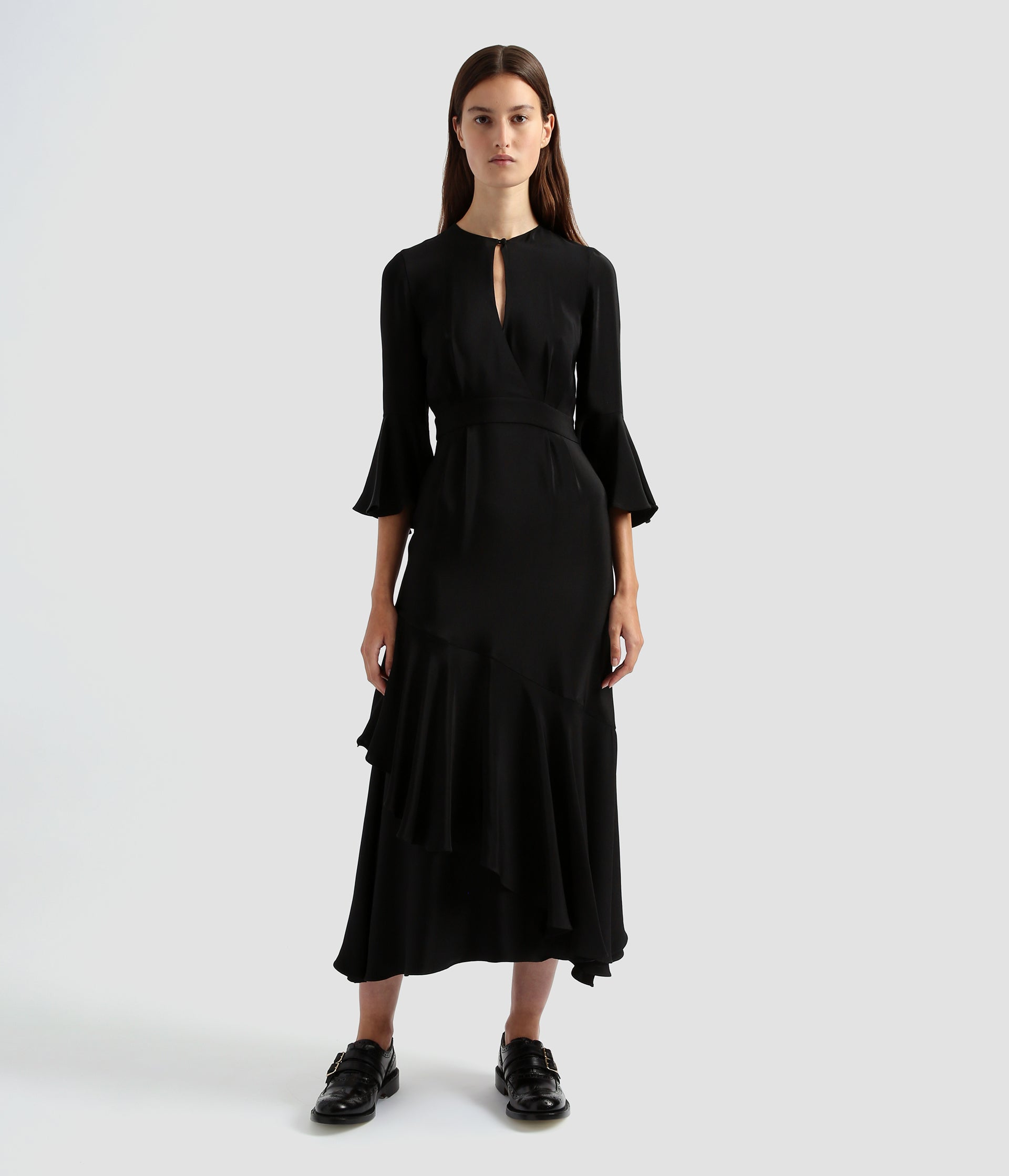 Florence dress by designer Erdem. Made from black silk crepe this florence dress features a tiered skirt with a keyhole neckline and loose flared sleeves. 