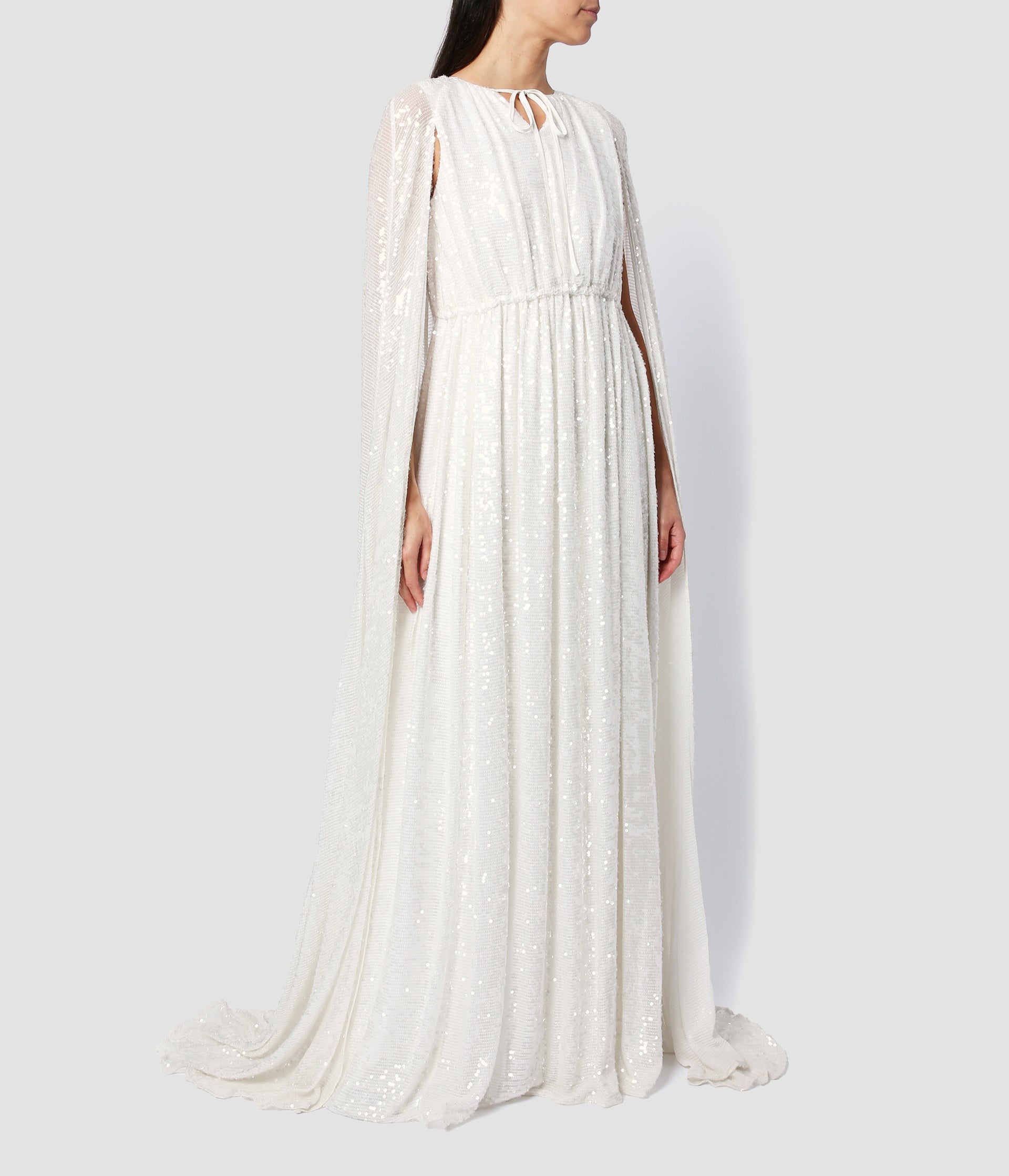 The kenley gown is a wedding dress from designer ERDEM. The dramatic sequined wedding dress, features a gathered dress with a floor length cape. 