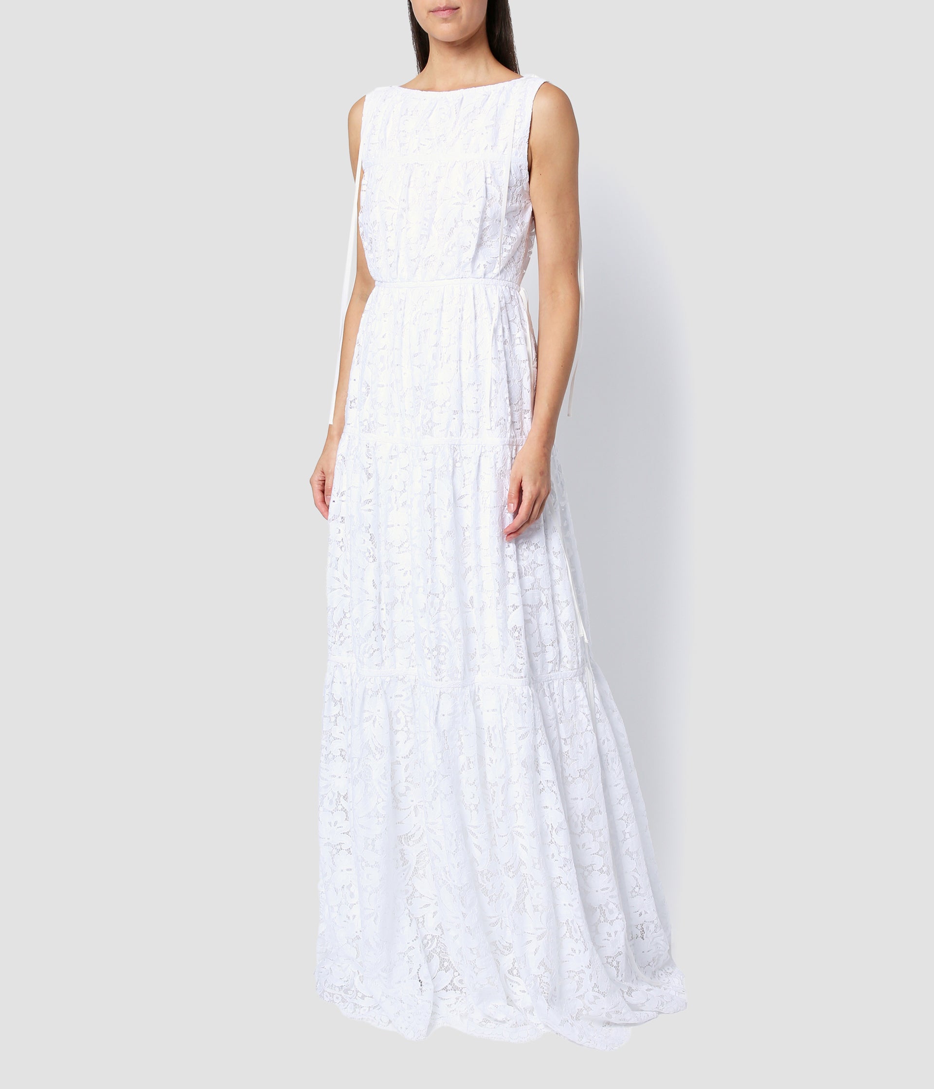 The Isla dress is a beautiful white floral lace wedding dress. WIth a tiered skirt, sleeveless design, this wedding dress is bohemian and relaxed. 