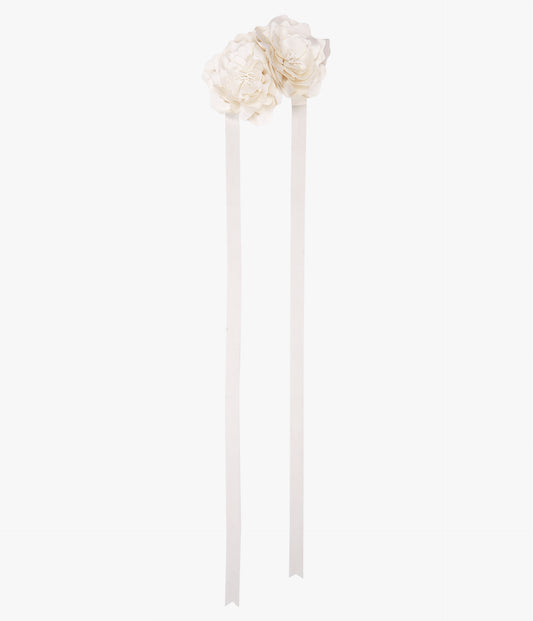 Complete a romantic bridal look with this oversized flower necklace in ivory satin from Erdem. 